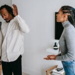 unhappy young black couple discussing relationships at home